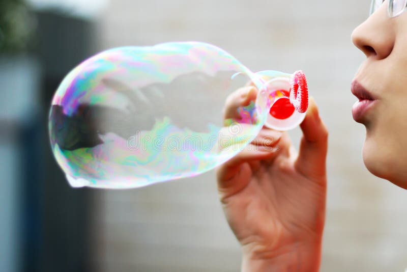 A beautiful woman blowing bubbles