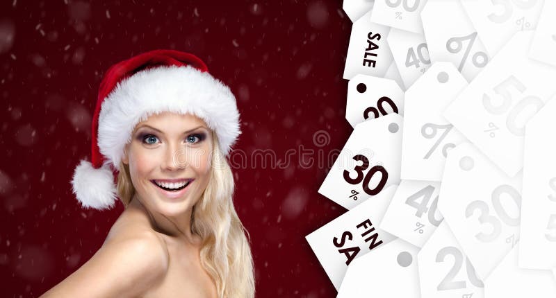 Beautiful woman in Christmas cap with good seasonal offer royalty free stock images Beautiful woman in Christmas cap with good seasonal offer royalty free stock images