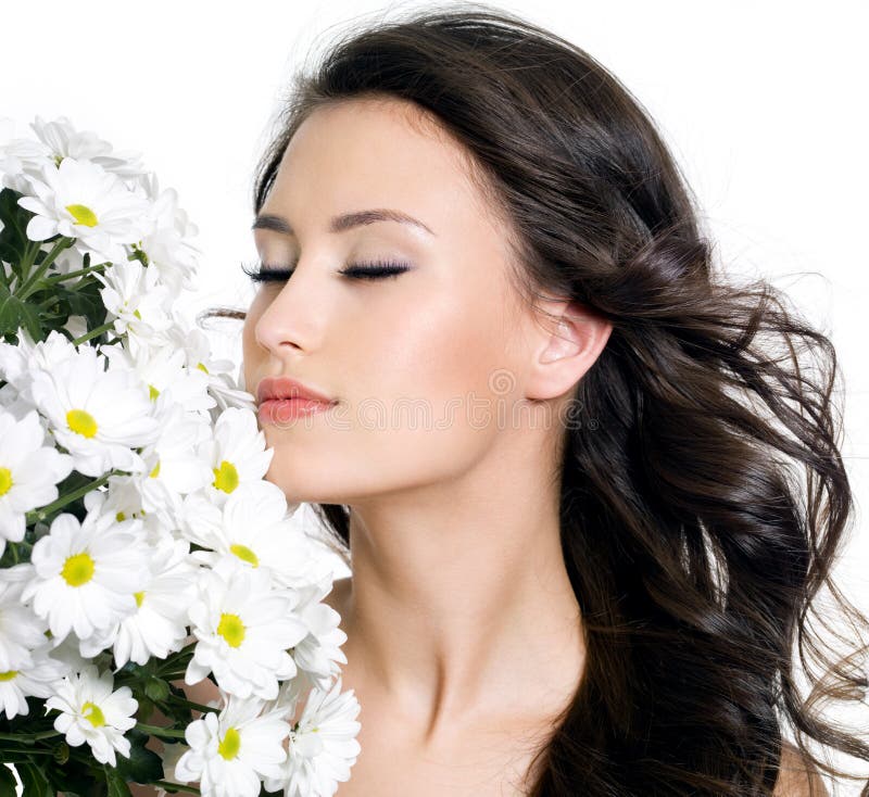 Beautiful woman with closed eyes and flowers