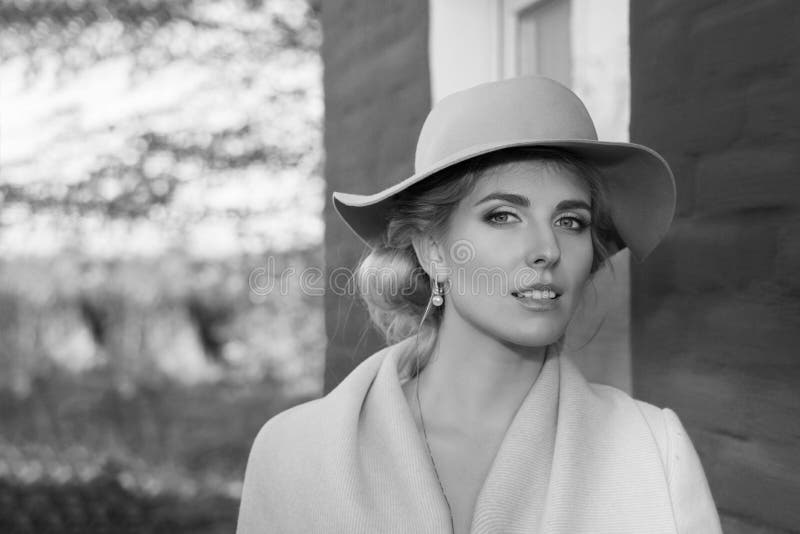 Beautiful woman in a coat hat and a white dress for a walk in an autumn park or forest. royalty free stock photography Beautiful woman in a coat hat and a white dress for a walk in an autumn park or forest. royalty free stock photography