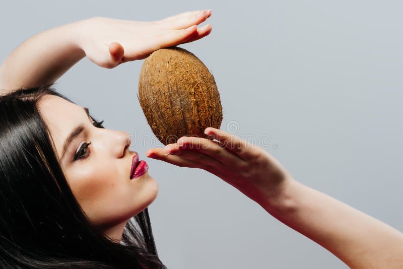 Beautiful woman with coconut in hands over white background, fashion portrait royalty free stock images Beautiful woman with coconut in hands over white background, fashion portrait royalty free stock images