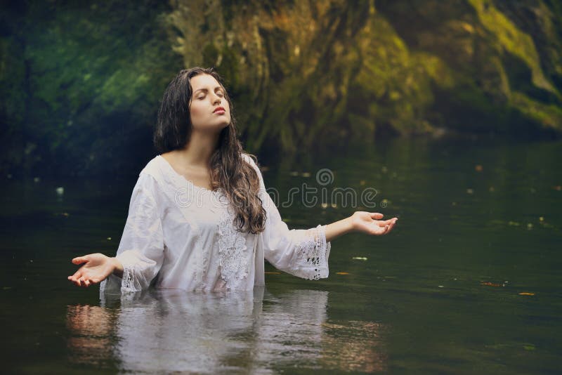 Beautiful woman in colorful forest stream. Beautiful nymph in colorful forest stream . Fantasy and surreal royalty free stock photo Beautiful woman in colorful forest stream. Beautiful nymph in colorful forest stream . Fantasy and surreal royalty free stock photo