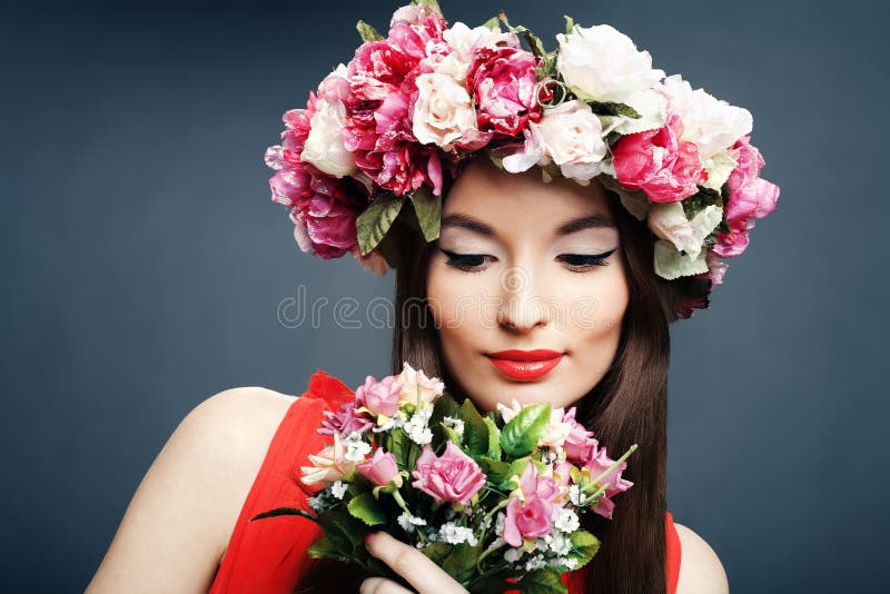 Beautiful woman with a crown on head and bouquet