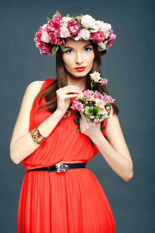 Beautiful woman with a crown on head and bouquet