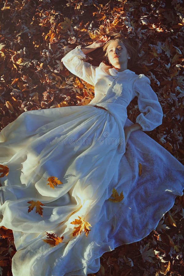 Beautiful woman daydreaming on a bed of leaves royalty free stock photography Beautiful woman daydreaming on a bed of leaves royalty free stock photography