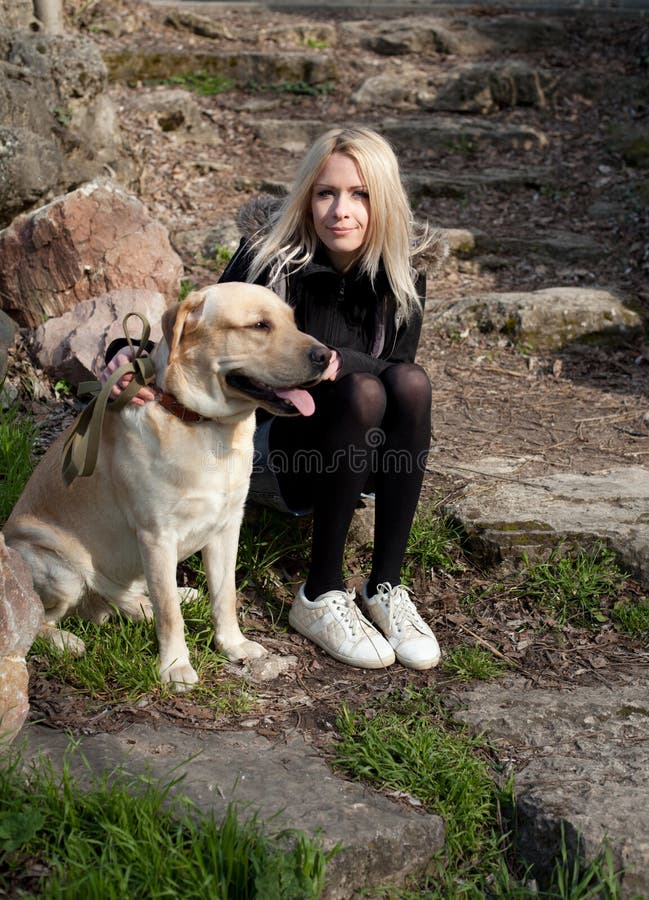 Beautiful woman with dog in the park