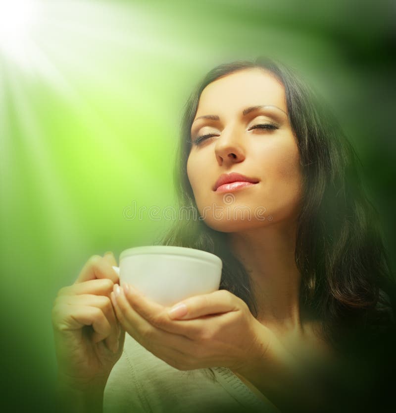 Beautiful woman drinking green tea