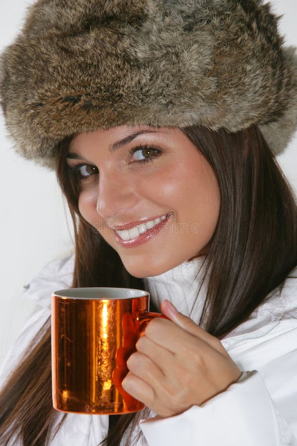 Beautiful woman drinking warm beverage