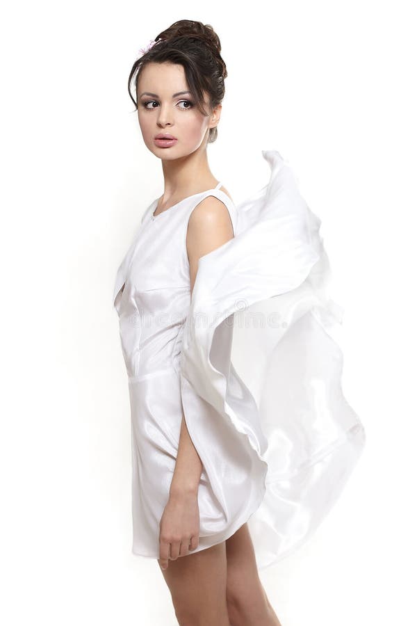 Beautiful woman earing white flying dress bride