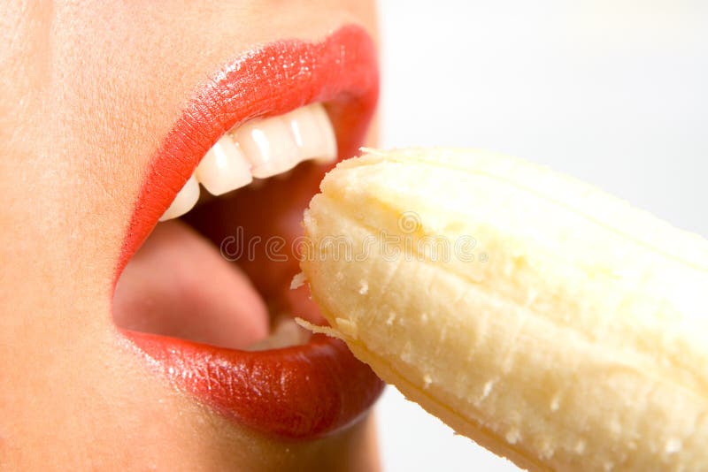 Beautiful woman eating an banana