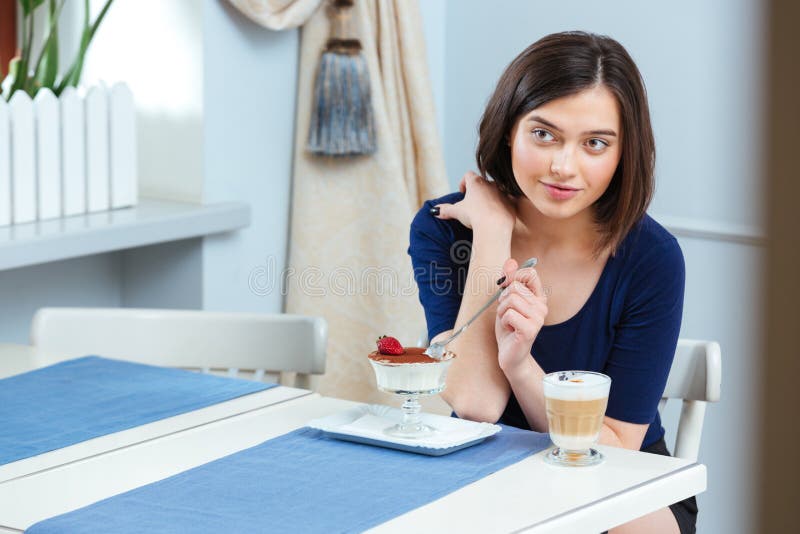 Beautiful Woman Eating Dessert And Drinking Coffee Latte In Cafe Stock