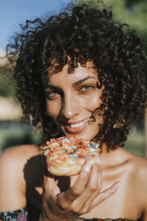 Beautiful woman eating a doughnut