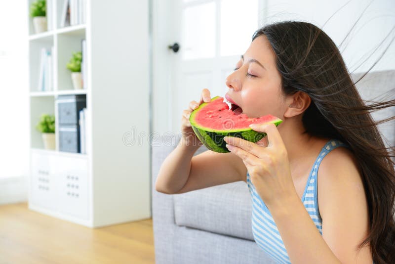 Beautiful woman eating fresh cold watermelon