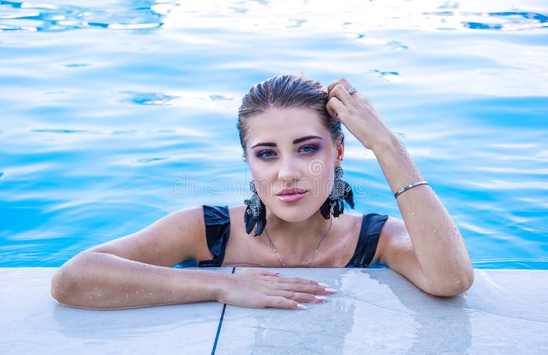 Beautiful woman emerged from the water. 