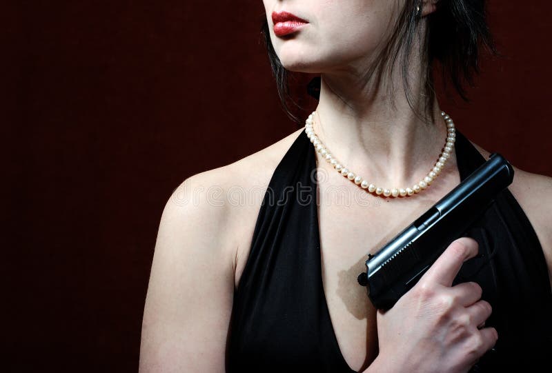 Beautiful woman in evening dress with gun, just lips and torso