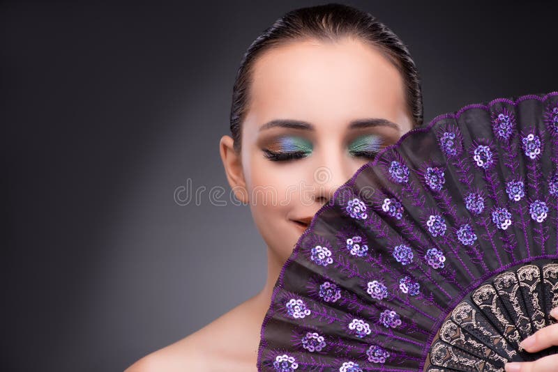 The beautiful woman with fan in fashion concept. East, beauty.