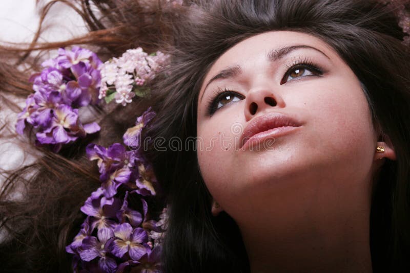 Beautiful young Asian woman with flowers in her hair. Beautiful young Asian woman with flowers in her hair