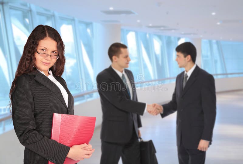 Beautiful woman with folder and businessmen