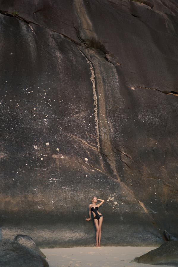 Beautiful woman among the giant rocks stock photo Beautiful woman among the giant rocks stock photo