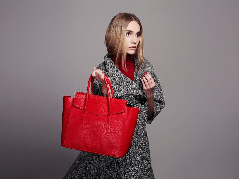 Beautiful Woman with Handbag. Beauty Fashion Girl in topcoat. winter Shopping