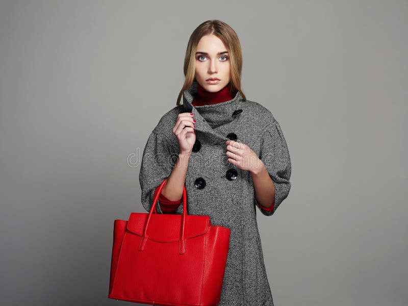 Beautiful Woman with Handbag. Beauty Fashion Girl in topcoat. winter Shopping