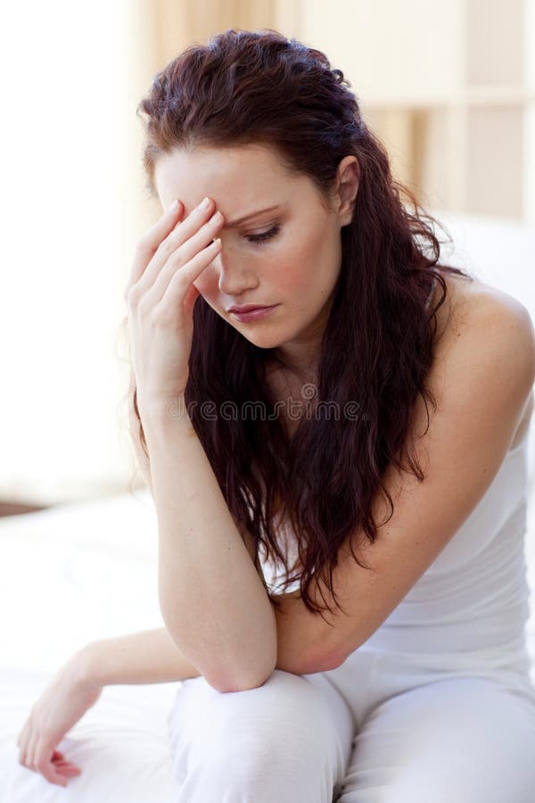 Beautiful woman having a headache in bed stock images