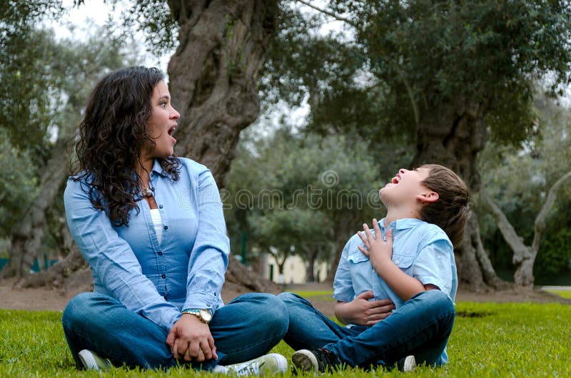 Beautiful woman and her cute little son looking at each other stock photo Beautiful woman and her cute little son looking at each other stock photo
