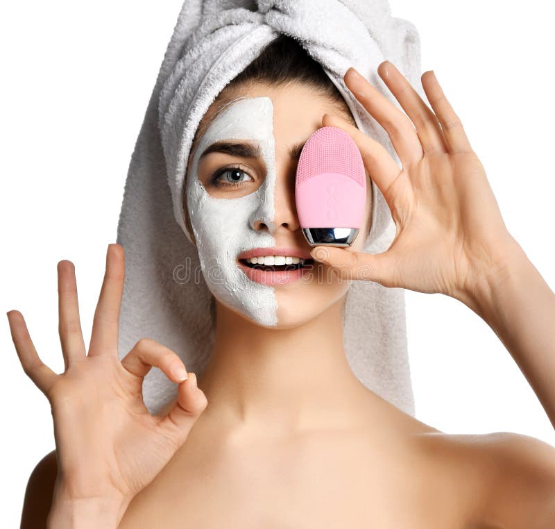 Beautiful woman hold pink face exfoliator brush silicone cleansing device for sensitive normal skin show ok sign