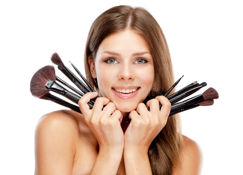 Beautiful woman holding makeup brushes