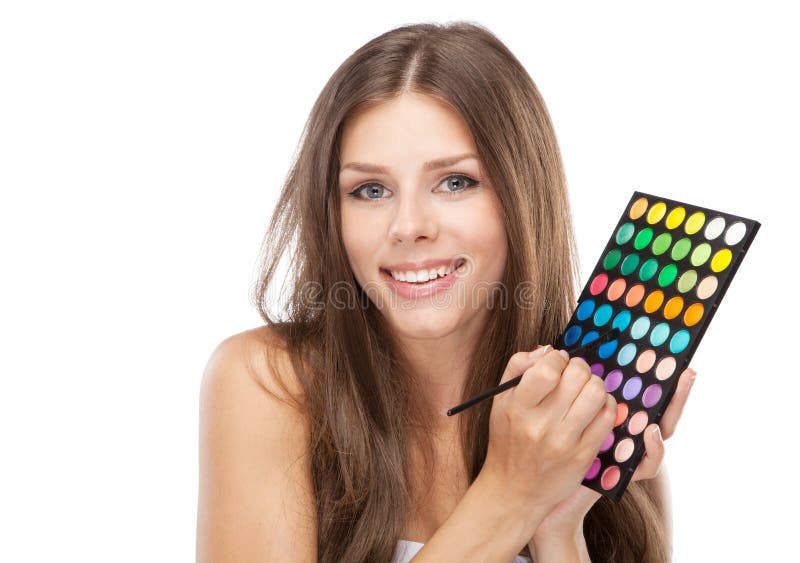 Beautiful woman holding a makeup palette