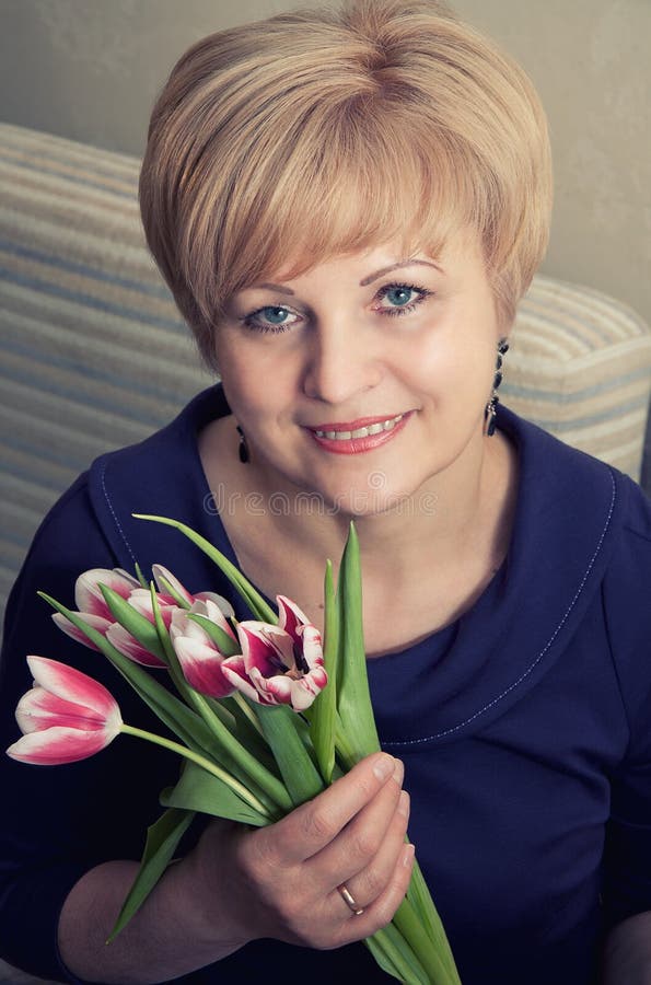 Beautiful woman holding tulips