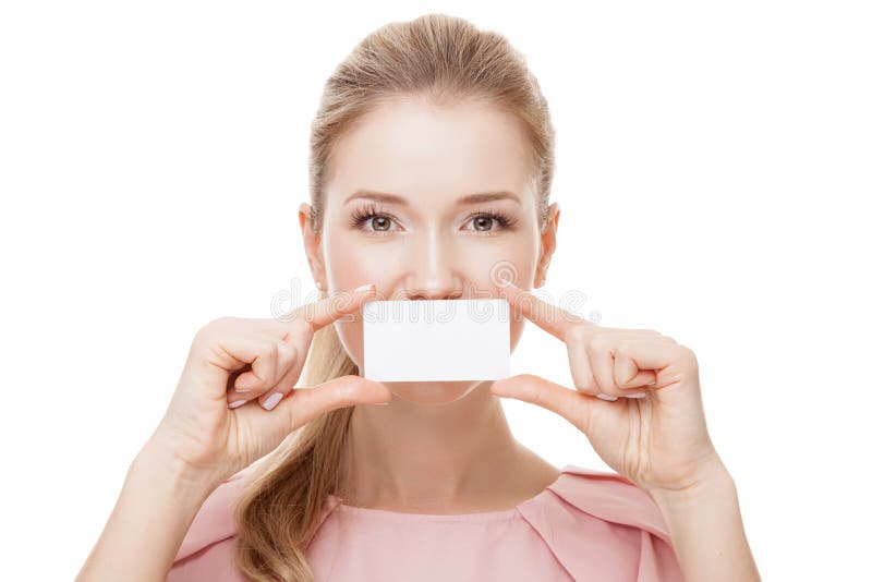Beautiful woman holding white card at front of her lips. Isolated.