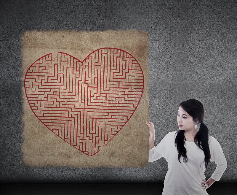 Beautiful woman holds heart maze map