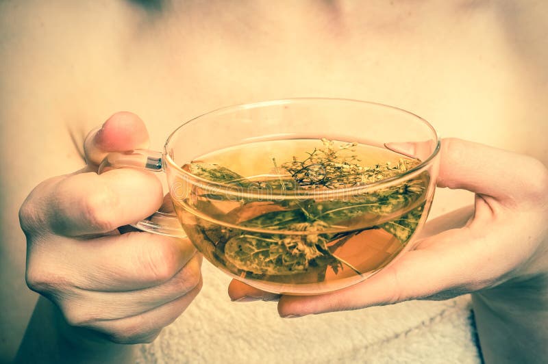 Beautiful woman with hot tea cup in her hands - retro style