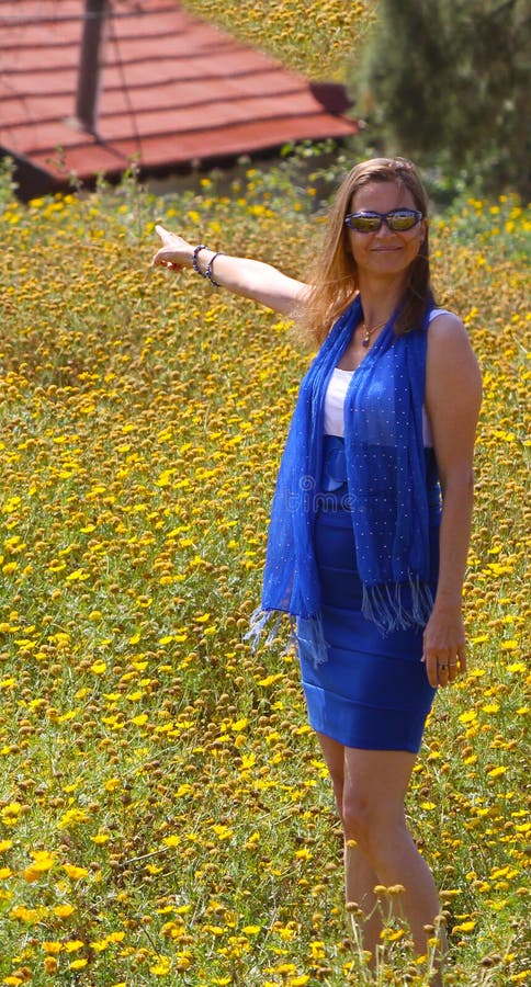 Beautiful woman with house in a flower field