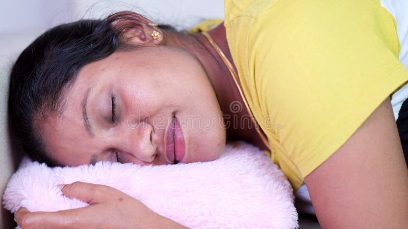 A Happy Woman Relaxing on Pink Pillow