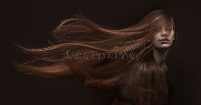 Beautiful woman with long hair on dark background