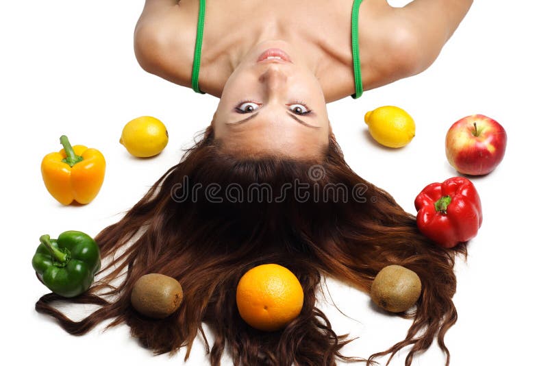 Beautiful woman lying with fruits and hair