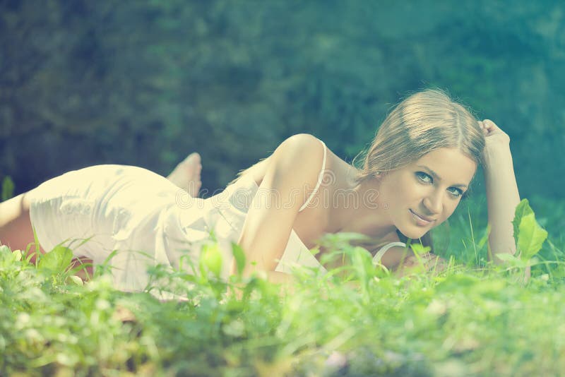 Beautiful Woman lying on the grass, rest in nature stock photography