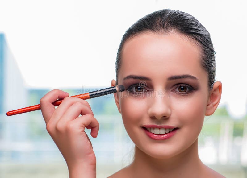 The beautiful woman during make-up cosmetics session. Lady, elegant.