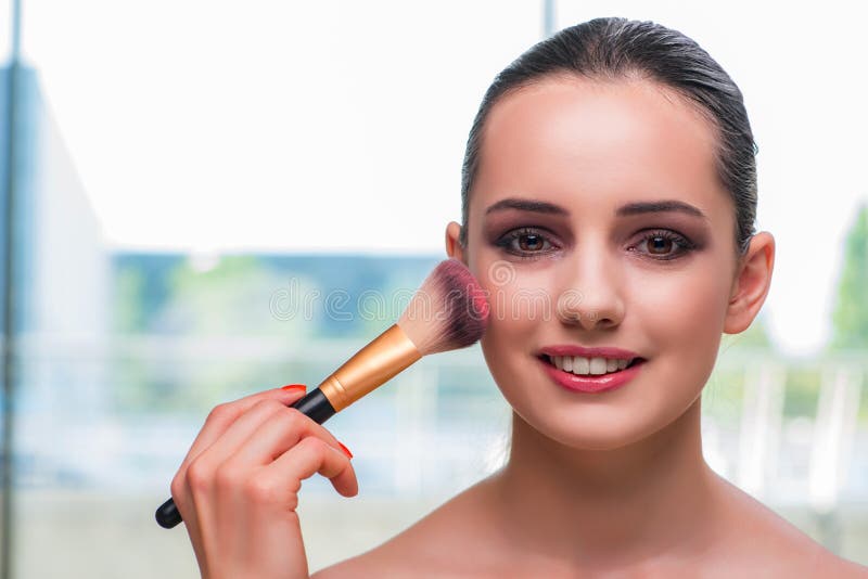 The beautiful woman during make-up cosmetics session.