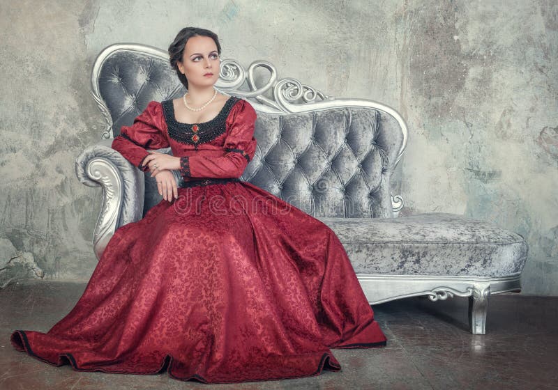Beautiful Woman in Medieval Dress on the Sofa Stock Photo - Image of ...
