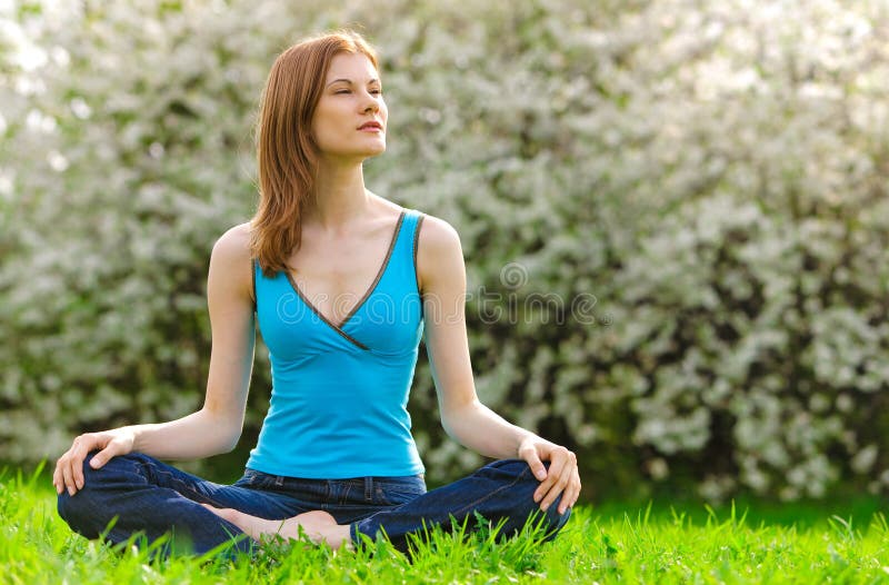 Beautiful woman meditating outdoors