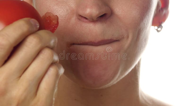 Beautiful woman mouth eating tomato. girl enjoying tasting tomato. healthy food and dieting concept. 4K