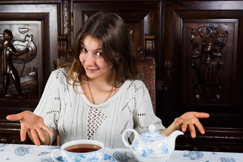 Beautiful woman offering you a cup of hot tea