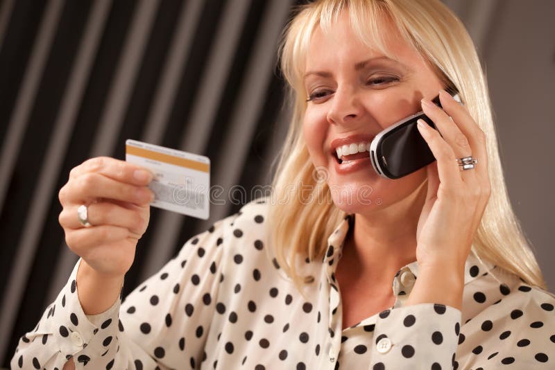 Beautiful Woman on Phone Holding Credit Card