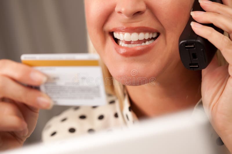 Beautiful Woman on Phone Holding Credit Card