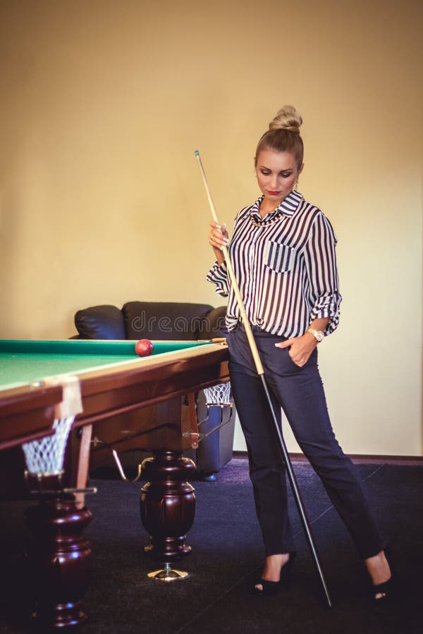 Beautiful woman play billiard
