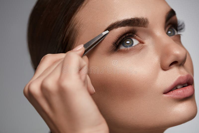 Beautiful Woman Plucking Eyebrows. Beauty Brows Correction