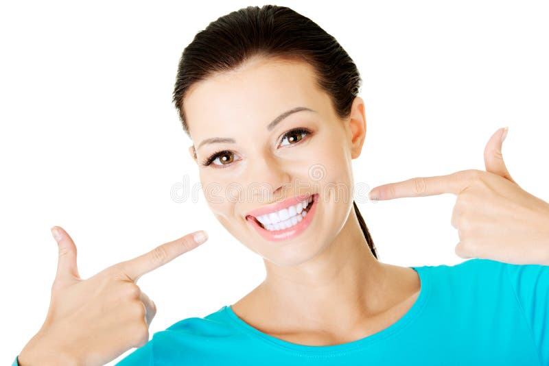 Beautiful woman pointing on her perfect white teeth. stock photography Beautiful woman pointing on her perfect white teeth. stock photography
